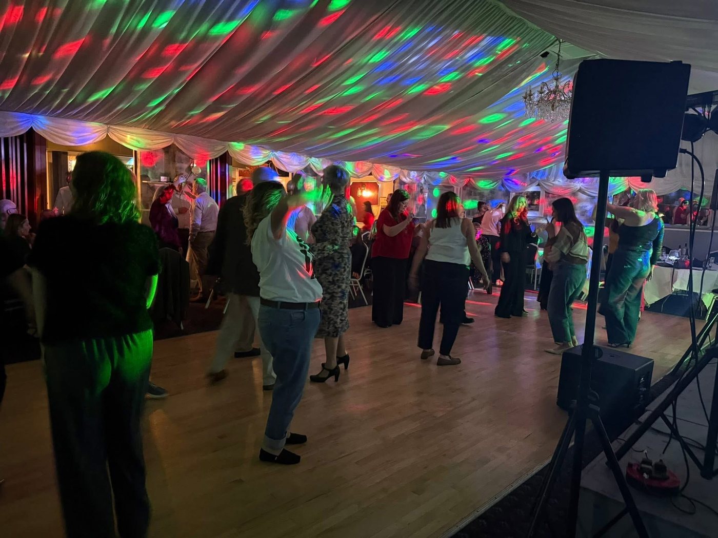 Guests dancing under the lights at a Gosport Lodge social evening