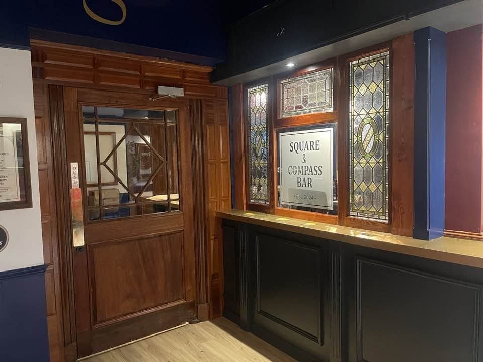 The Square and Compass Bar at the Gosport Masonic Centre, with stained-glass windows