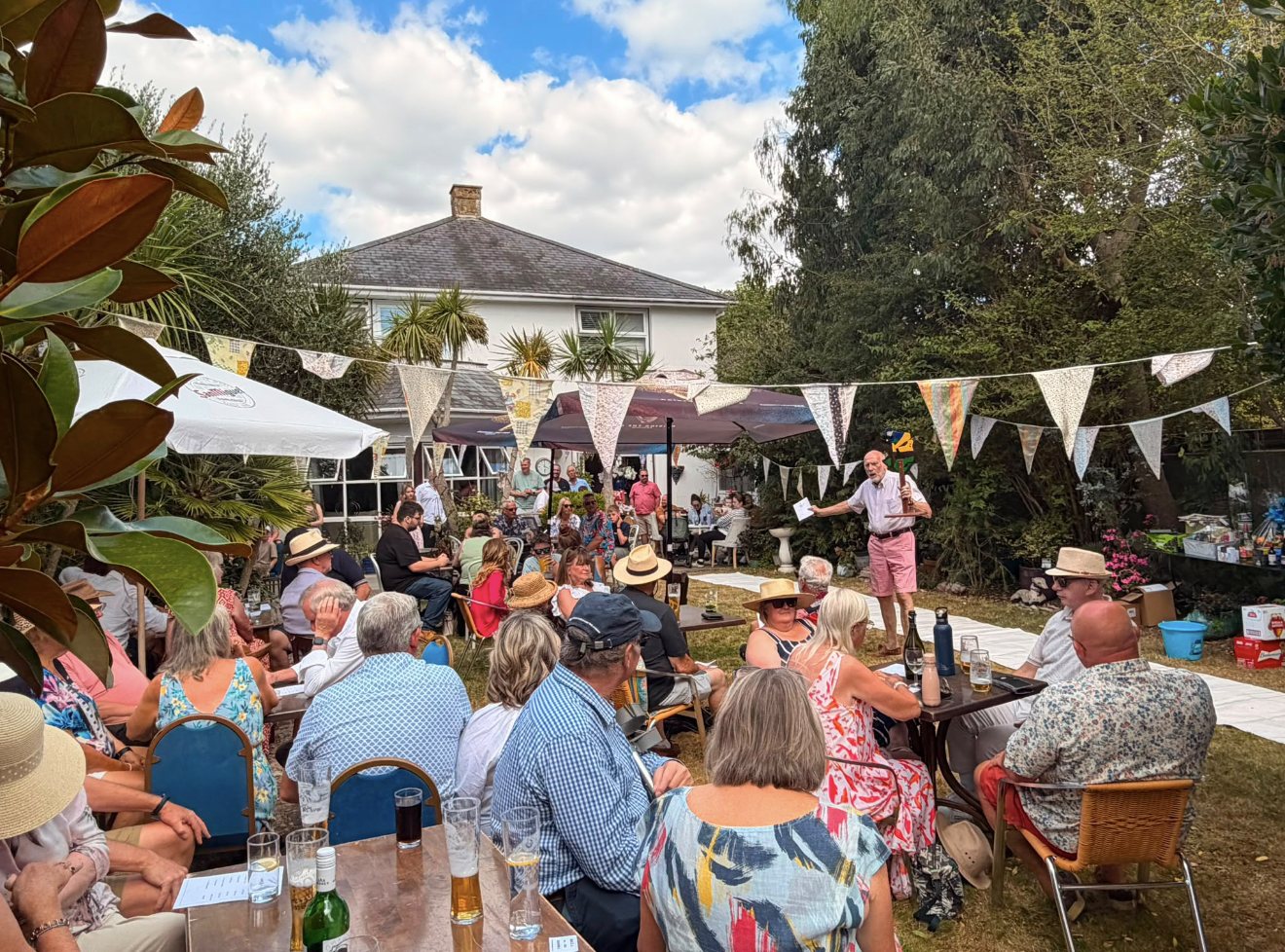 Members, partners and friends at a summer garden social in the sunshine