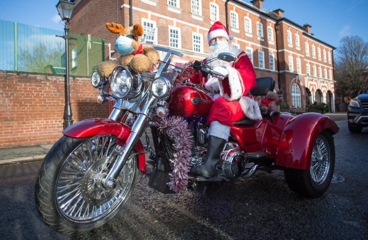 A Widows Sons rider dressed as Father Christmas on a decorated Harley-Davidson trike during the toy run